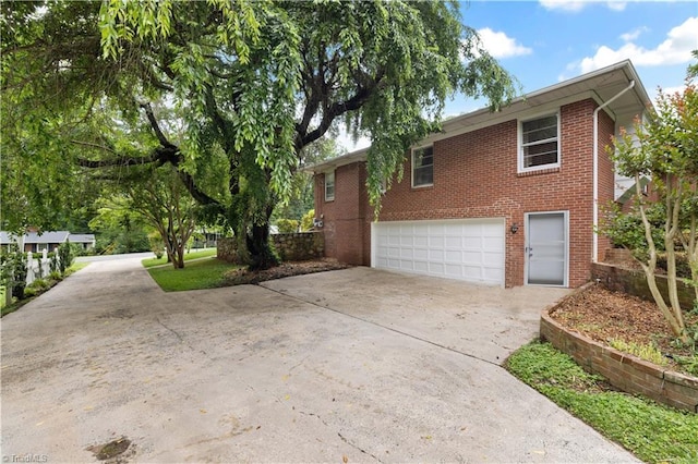 252 Lucerne Ln NW, Winston-Salem, NC 27104 - view of property exterior featuring driveway, brick siding, and a garage