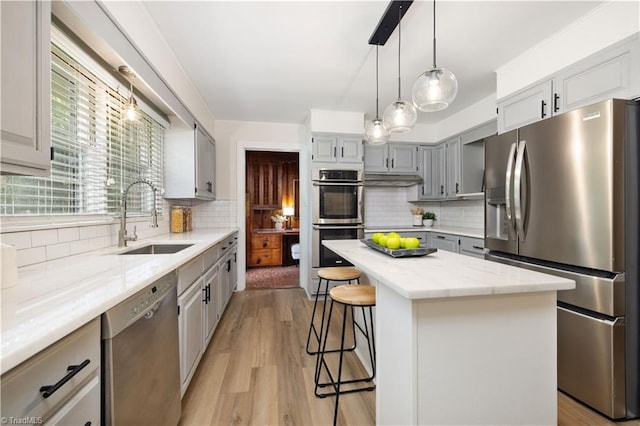 252 Lucerne Ln NW, Winston-Salem, NC 27104 - kitchen with stainless steel appliances, a sink, decorative backsplash, and a breakfast bar area