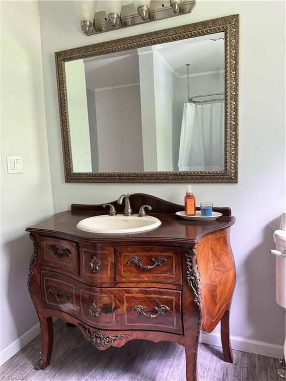 2226/2234 NC-268, Pilot Mountain, NC 27041 - bathroom featuring baseboards, wood finished floors, and vanity