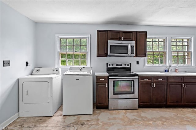 2226/2234 NC-268, Pilot Mountain, NC 27041 - kitchen with stainless steel appliances, washing machine and dryer, a sink, and plenty of natural light