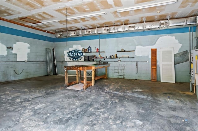 2226/2234 NC-268, Pilot Mountain, NC 27041 - basement featuring a workshop area, concrete block wall, and a garage