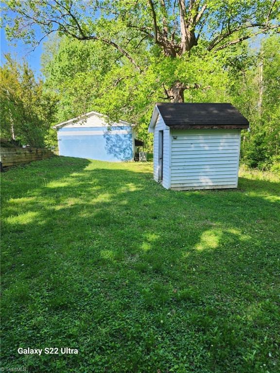 2226/2234 NC-268, Pilot Mountain, NC 27041 - view of grassy yard with a storage unit and an outbuilding