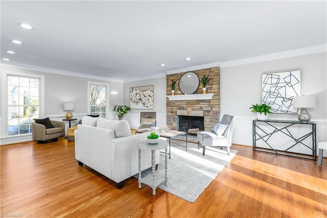 living room featuring a fireplace, hardwood / wood-style flooring, and ornamental molding