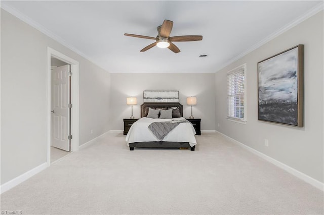 carpeted bedroom featuring ceiling fan and crown molding