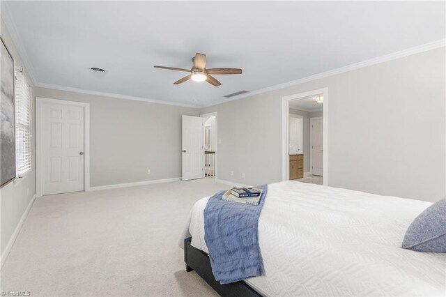 bedroom with ensuite bath, ceiling fan, carpet floors, and ornamental molding