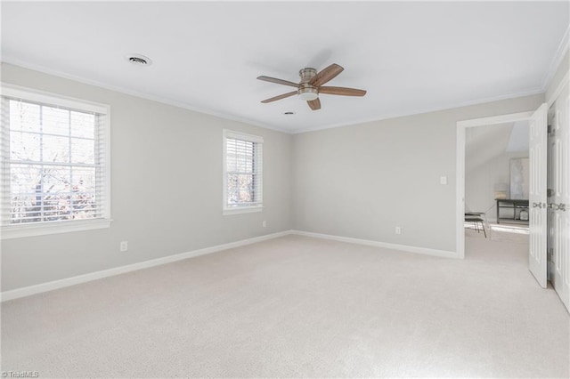 carpeted spare room with ceiling fan and ornamental molding