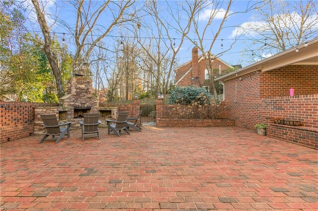 view of patio / terrace featuring an outdoor stone fireplace