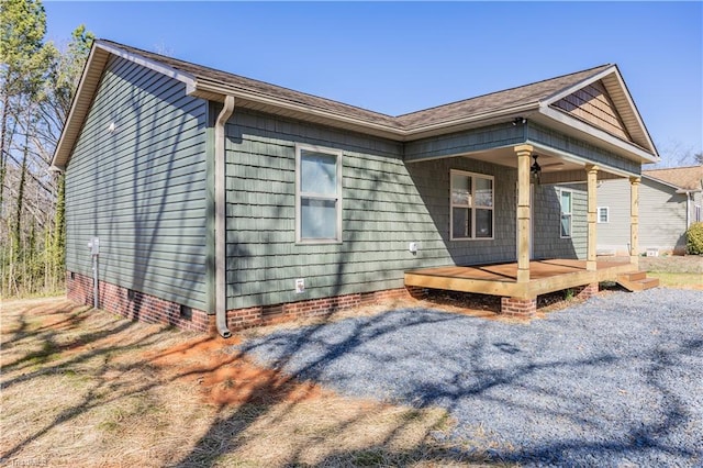 rear view of property featuring a porch and crawl space