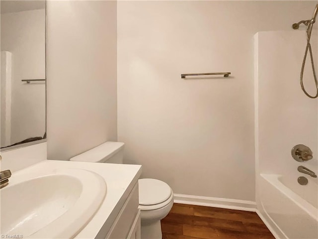 full bathroom featuring shower / washtub combination, hardwood / wood-style floors, vanity, and toilet