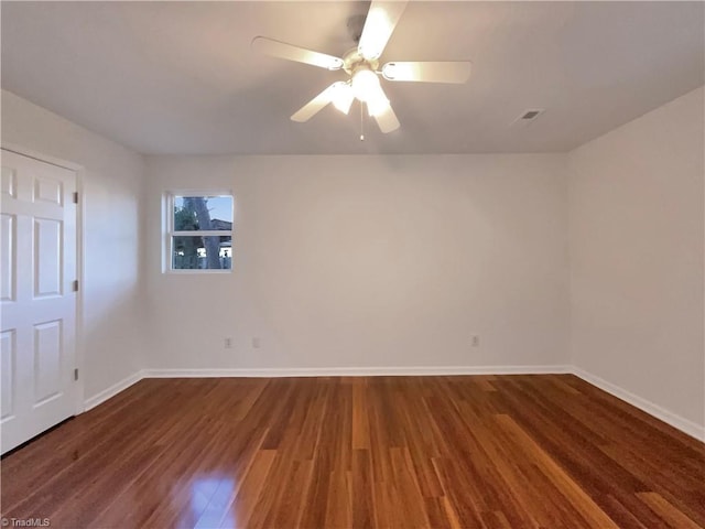 unfurnished room with dark hardwood / wood-style floors and ceiling fan