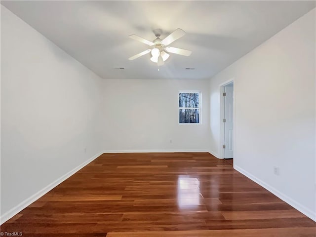 empty room featuring ceiling fan and dark wood-type flooring