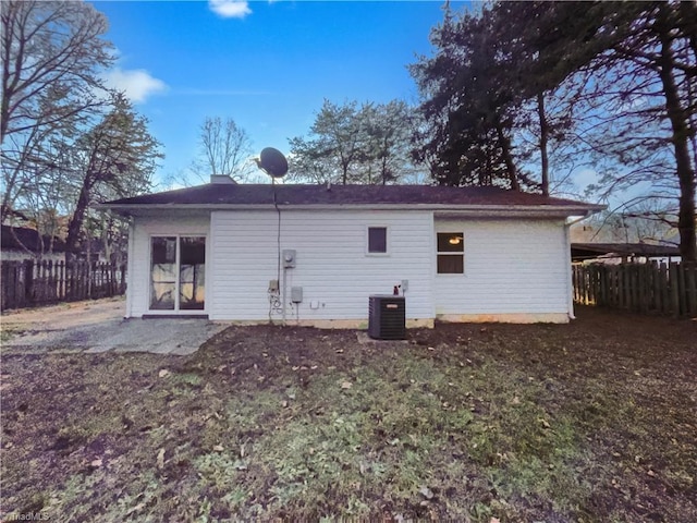 rear view of property featuring cooling unit