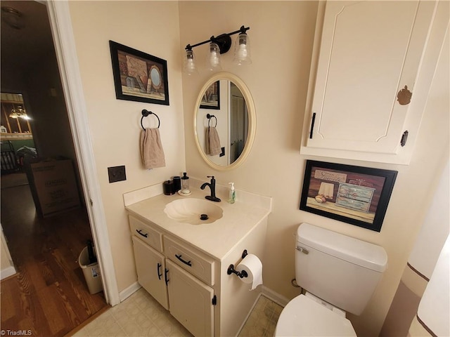 bathroom featuring hardwood / wood-style flooring, toilet, and vanity