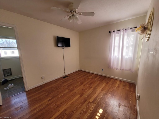 unfurnished room featuring hardwood / wood-style flooring and ceiling fan