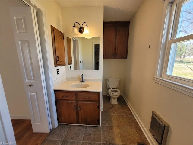 bathroom featuring vanity, toilet, and tile patterned floors