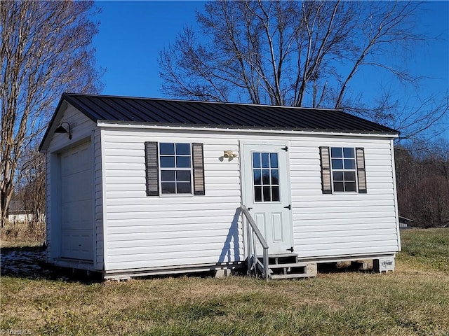 view of outbuilding with a lawn