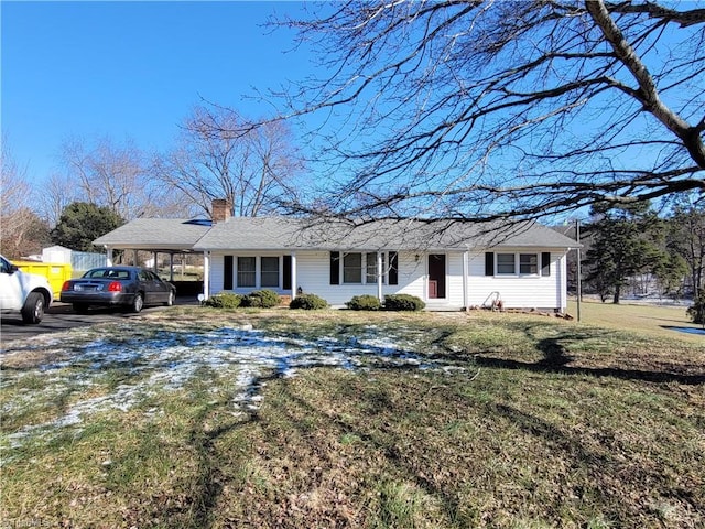 single story home featuring a front lawn and a carport