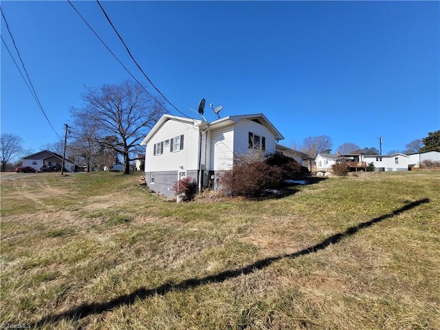 view of side of home featuring a yard