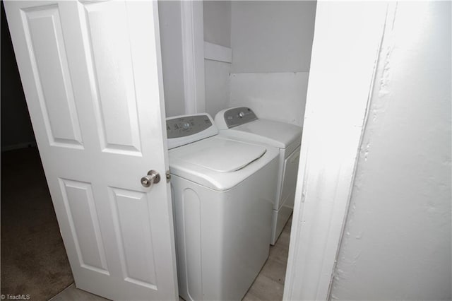 clothes washing area featuring washer and clothes dryer