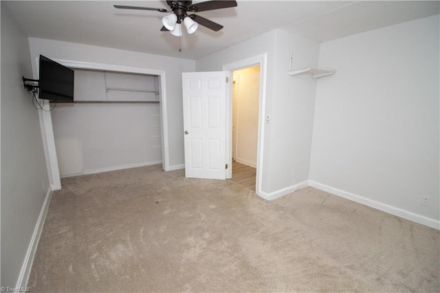 unfurnished bedroom with carpet, baseboards, a closet, and a ceiling fan