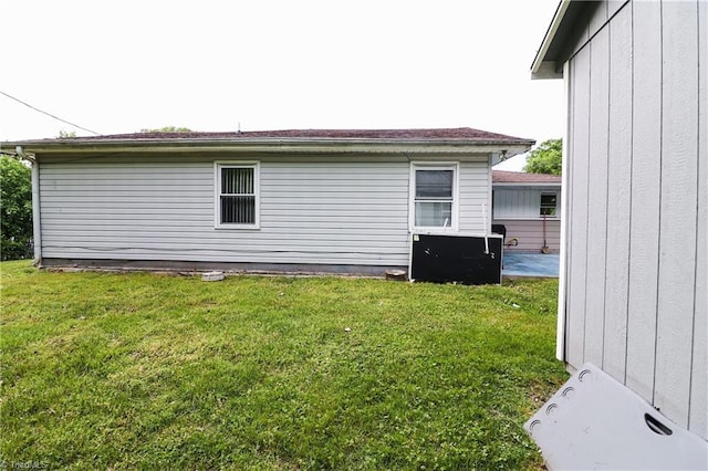view of side of home with a lawn