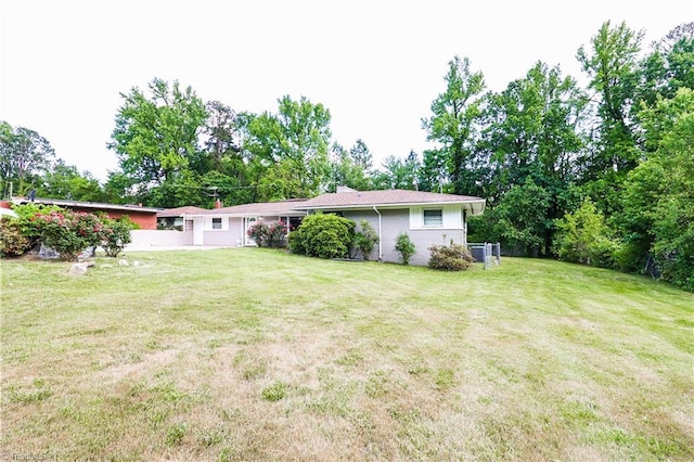 rear view of house with a yard
