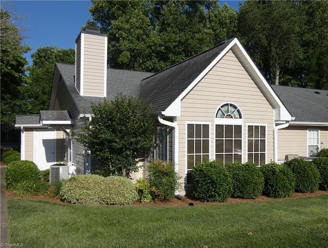 3982 Westridge Meadow Cir, Clemmons, NC 27012 - view of front of home featuring a chimney, a front lawn, and central AC unit