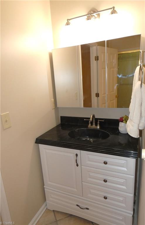 3982 Westridge Meadow Cir, Clemmons, NC 27012 - bathroom featuring vanity, tile patterned flooring, and baseboards