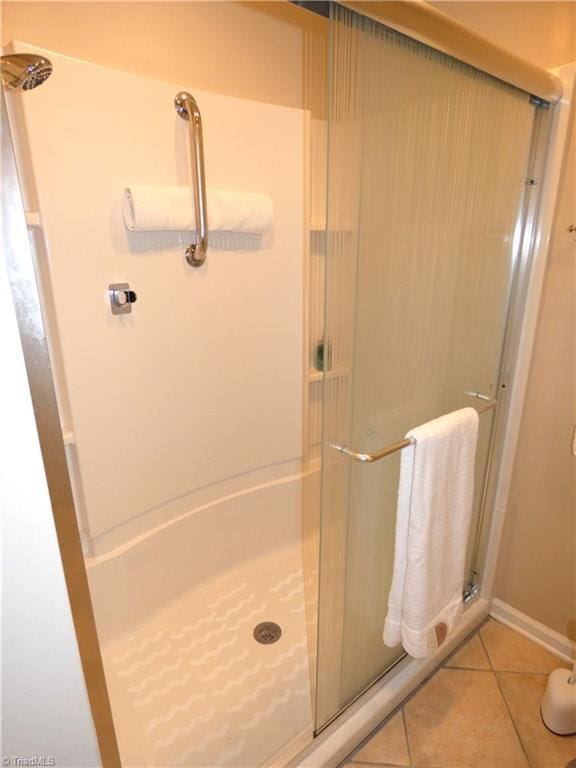 3982 Westridge Meadow Cir, Clemmons, NC 27012 - full bathroom featuring a stall shower, tile patterned floors, and baseboards