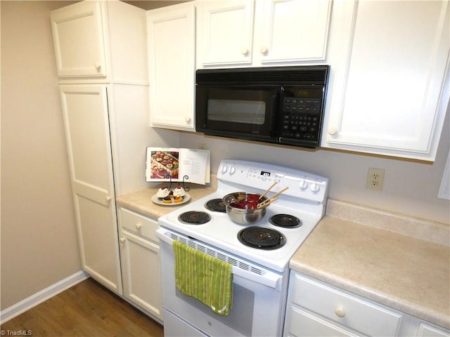 3982 Westridge Meadow Cir, Clemmons, NC 27012 - kitchen with white range with electric stovetop, black microwave, light countertops, and white cabinetry