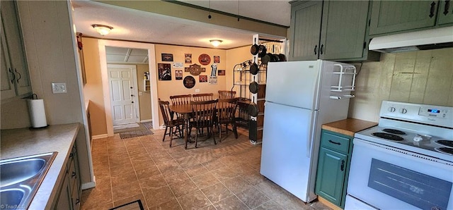 kitchen featuring green cabinetry, sink, and white appliances