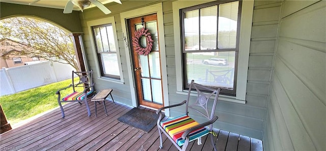 wooden deck featuring ceiling fan