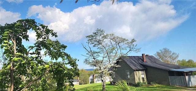 view of side of property with a yard