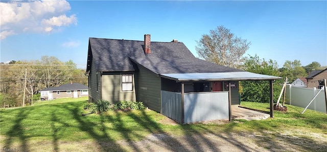 view of outbuilding with a carport and a yard