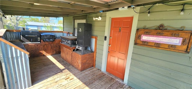 wooden deck featuring a grill