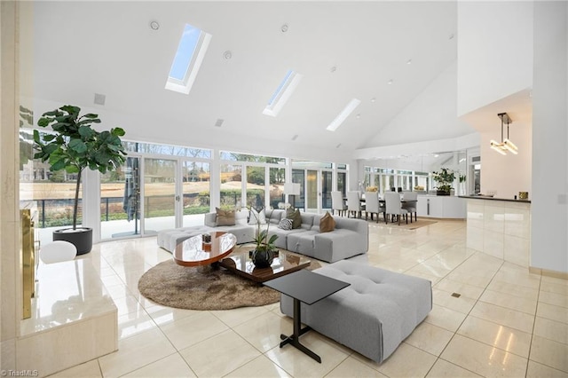 living area with high vaulted ceiling, a skylight, and light tile patterned floors