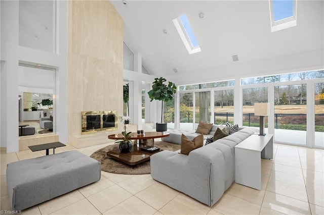 living room with a wealth of natural light, a skylight, light tile patterned floors, and a premium fireplace