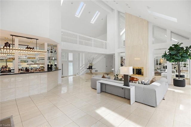 living room featuring high vaulted ceiling and light tile patterned floors