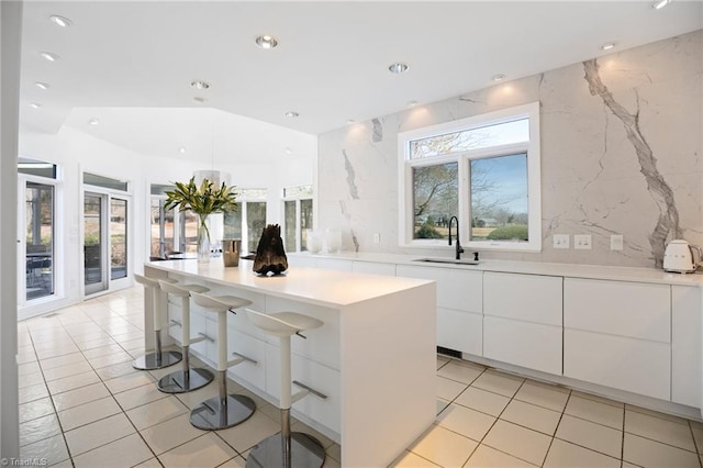 kitchen featuring plenty of natural light, modern cabinets, and a sink