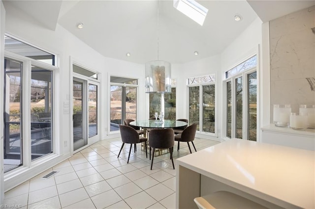 sunroom with a skylight and visible vents