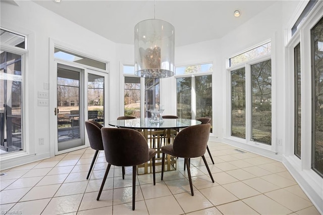 sunroom featuring a chandelier