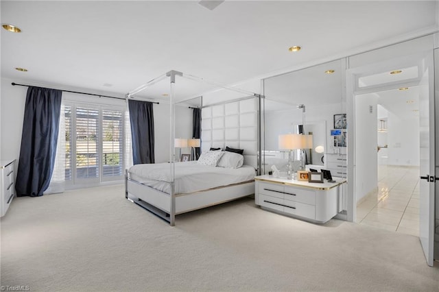 bedroom featuring light tile patterned floors and light colored carpet