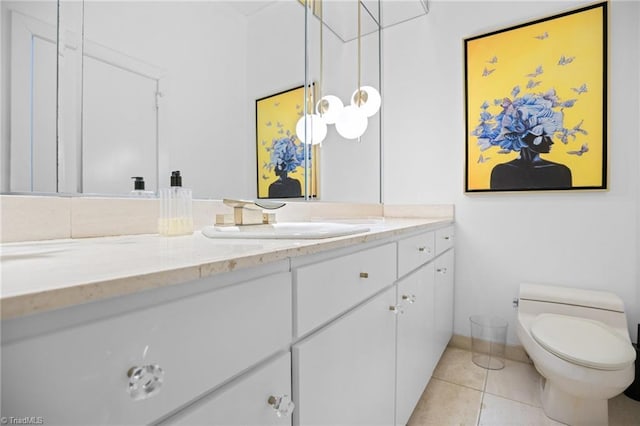 bathroom with vanity, tile patterned flooring, and toilet