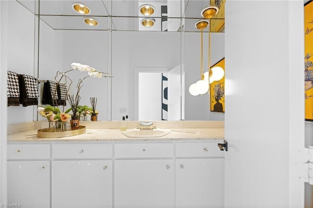 bathroom featuring a sink and double vanity