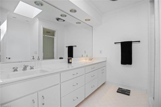 bathroom with a skylight, a sink, ornamental molding, a shower stall, and double vanity