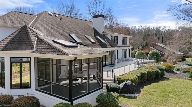 back of house featuring a sunroom, a yard, a chimney, and crawl space