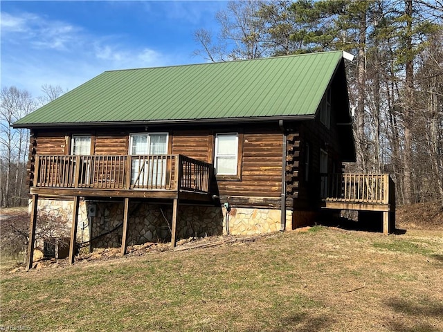 back of property with a deck and a lawn