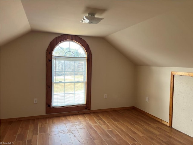 bonus room featuring vaulted ceiling and hardwood / wood-style floors