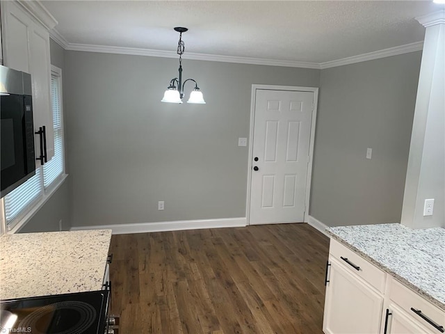 unfurnished dining area featuring crown molding, dark hardwood / wood-style flooring, and a chandelier