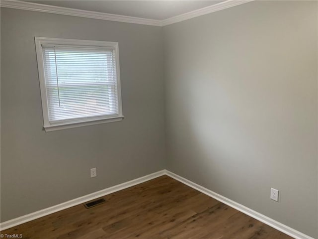 empty room with crown molding and dark wood-type flooring